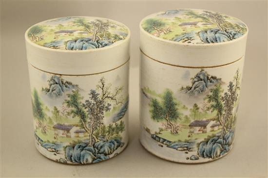 Two Chinese famille rose cylindrical jars and covers, 13cm and 13.5cm